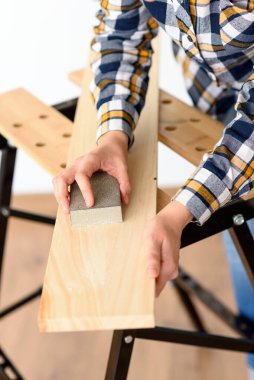 Evdeki bir kadının tezgahtaki tahtayı zımparalarken yakın plan fotoğrafı. Yüksek kalite fotoğraf.