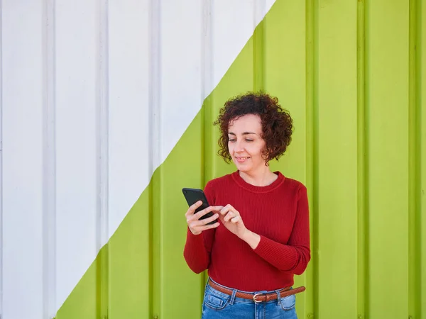 Caucasian Young Woman Holding Smartphone Green White Wall — Stock Photo, Image