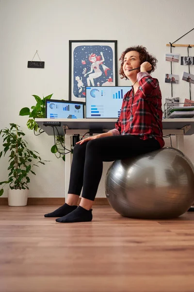 Woman teleworking sitting on a fitball — Stock Photo, Image