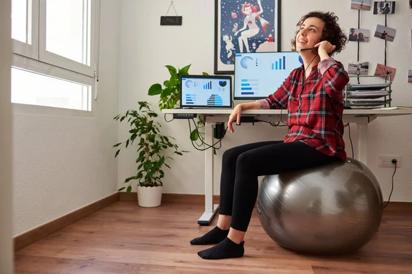 Woman teleworking sitting on a fitball — Stock Photo, Image