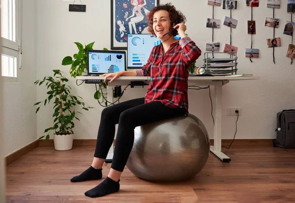 Woman teleworking sitting on a fitball — Stock Photo, Image