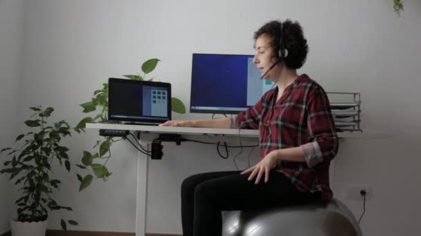 Woman teleworking sitting on a fitball — Stock Video