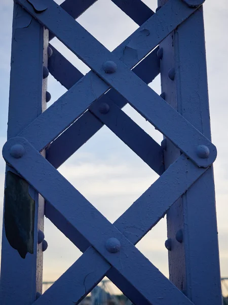 Detalle del puente remachado pintado contra el cielo azul . Imagen De Stock