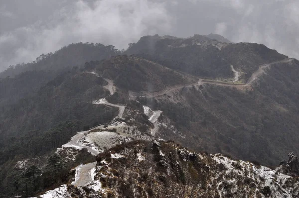 Ariel, dağın tepesindeki hareketli yol manzarası bulutlu gökyüzü ile güzel bir dağ yamacı..