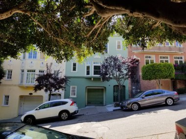 San Francisco Caddesinde parlak renkli evler ve arabalar bir tepede