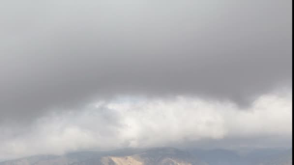 The formation and movement of clouds up to the steep mountain slopes of the  mountains of Central Caucasus peaks. — Stock Video