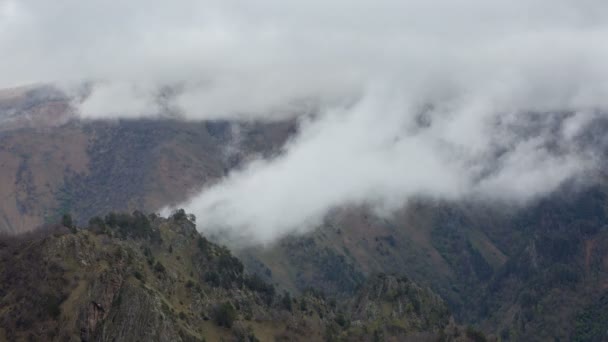 The formation and movements of clouds up to the steep slopes of the  mountains of Central Caucasus peaks. — Stock Video