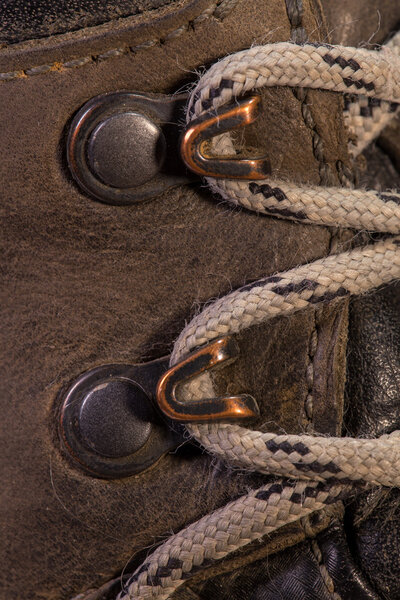 Detail of trekking shoes hook and loop for the strap.