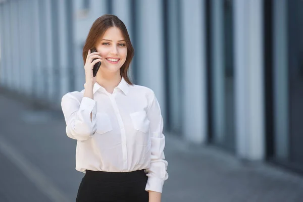 Gyönyörű nő beszél egy mobiltelefon a város központjában — Stock Fotó