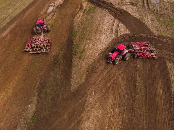 Dos tractores con una grada de disco arar el campo para la siembra. Fotografía aérea. —  Fotos de Stock