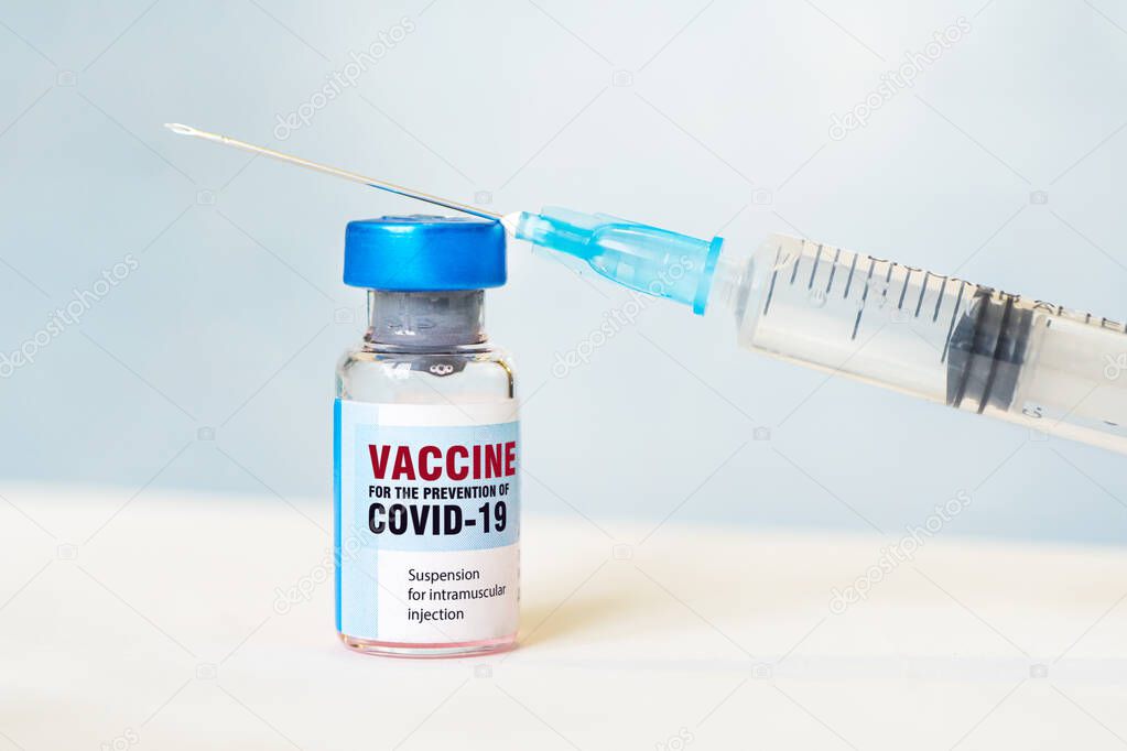 Closeup of syringe and injection coronavirus, covid-19 vaccine disease prepare for human, medicine and drug concept. blue background