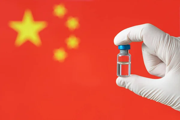Corona virus COVID-19 Vaccine injection hand hold Doctor or nurse on flag China background. Protect immunization and treatment from corona virus infection. medicine concept.
