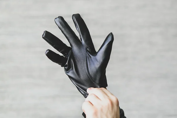 Man Puts Black Leather Gloves His Hands Gray Background Leatherette — Stock Photo, Image