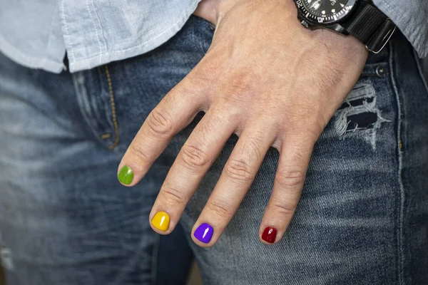 A man with painted nails. Design of male nails. men's manicure. Demonstration of a beautiful nail design.
