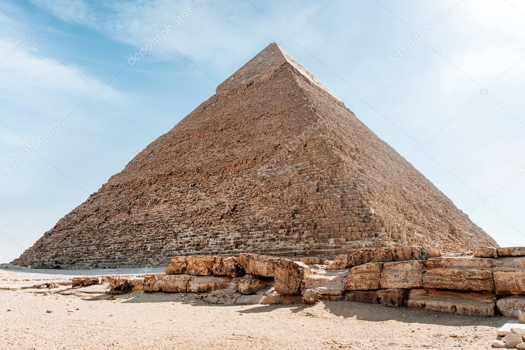 The high pyramid of Chephren on the background of a blue sky with clouds, Giza, Cairo, Egypt. second pyramid