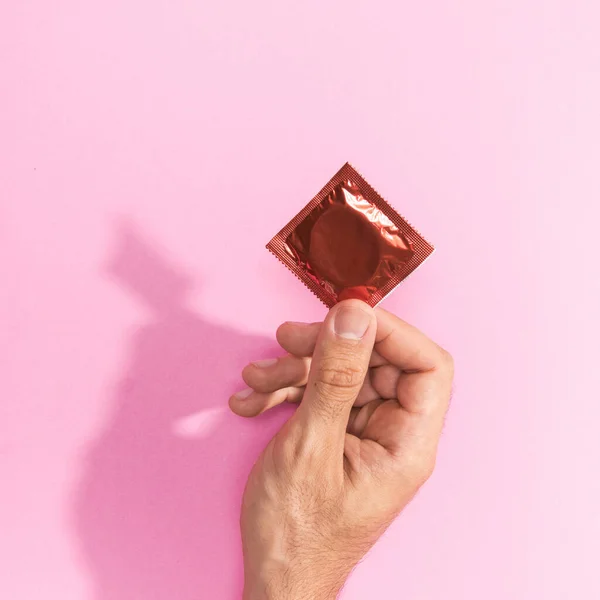 Close Man Holding Red Condom Resolution High Quality Beautiful Photo — Stockfoto