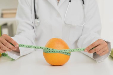 close up nutritionist measuring orange. Resolution and high quality beautiful photo