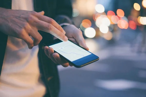 Close up of male hands with smartphone. Tourist using GPS map navigation on application screen for direction to destination address in the city. Travel and technology concept