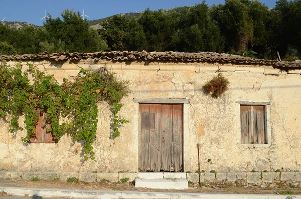 Old house with closed wooden shutters and door on window,Kefalonia,Greece Stock Photo