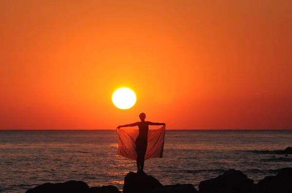 Gün batımında kadın silueti