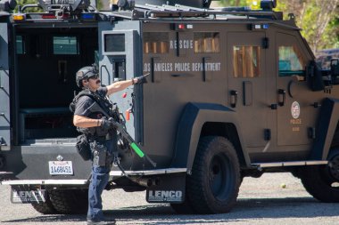 Reseda, California, ABD - 24 Şubat 2021: LAPD SWAT ekibi, polis memurları ve LAFD itfaiyecileri ve helikopterleri Reseda 'daki bir silahlı adam ihbarına yanıt verdiler. Şüphelilerden biri gözaltına alındı..