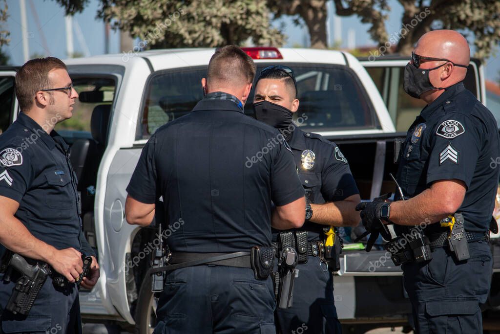 Ventura, California, United States -  August 7, 2020: Officers from the City of Ventura Police Department conduct a search of a suspect's vehicle at Ventura Harbor..  Two firearms were seized and two suspects arrested.  The incident happened at Ventu