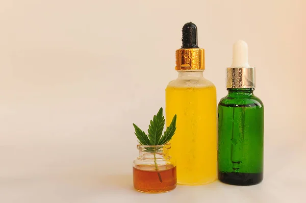 Cannabis blooms, cbd oil, cosmetics. Marihuana extract in cosmetology. Flat lay, white background. Home relaxation, spa recreation, pastime therapy.