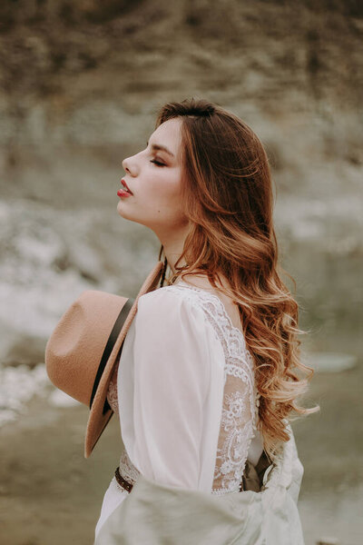 Portrait of young woman  with red lipstick posing outdoors