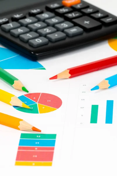 Colorful charts with pencils and calculator — Stock Photo, Image