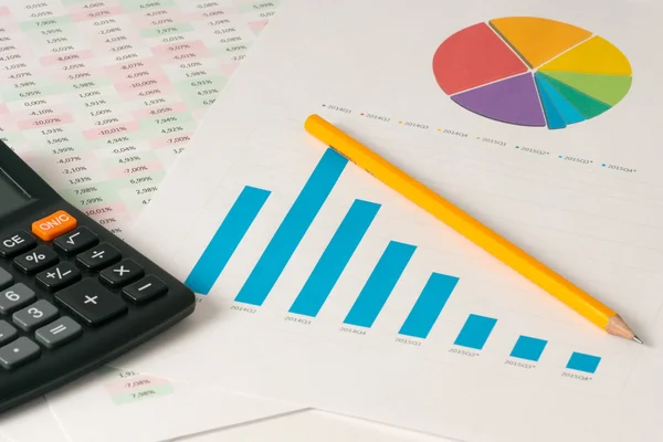 Multi color pie and bar charts with calculator — Stock Photo, Image