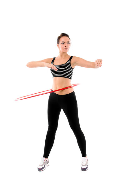 Woman training with hula hoop isolated on white