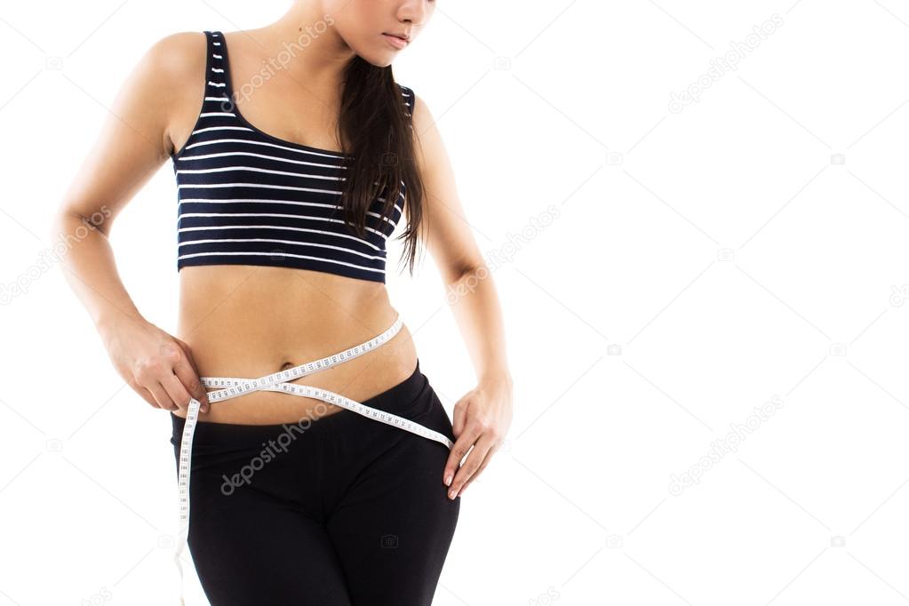 Slim girl with measuring tape isolated on white