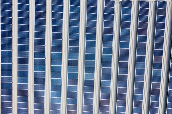 Aerial view of rows of photovoltaic solar panels on a commercial rooftop, Sydney, Australia.