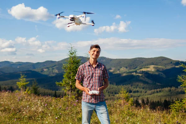 Aerial drone footage shooting of summer Carpathins. Man operating copter controller in mountains. Tourist filming wild nature