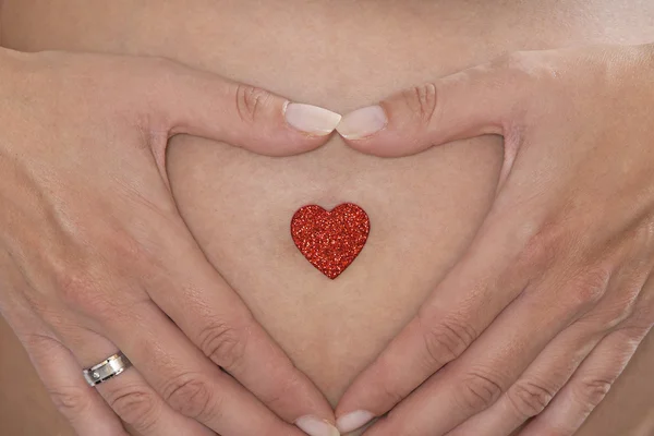 Baby belly and mother hands — Stock Photo, Image