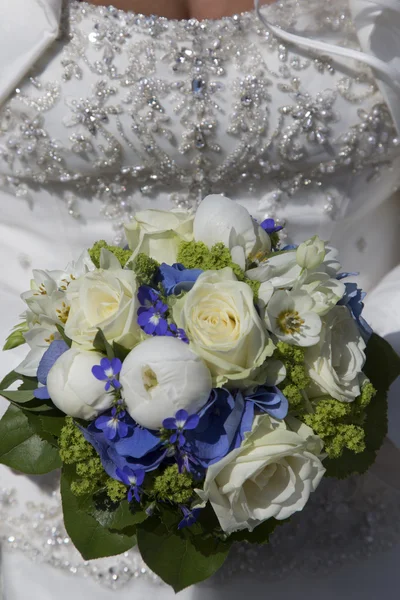 Bridal bouquet on white wedding dress — Stock Photo, Image