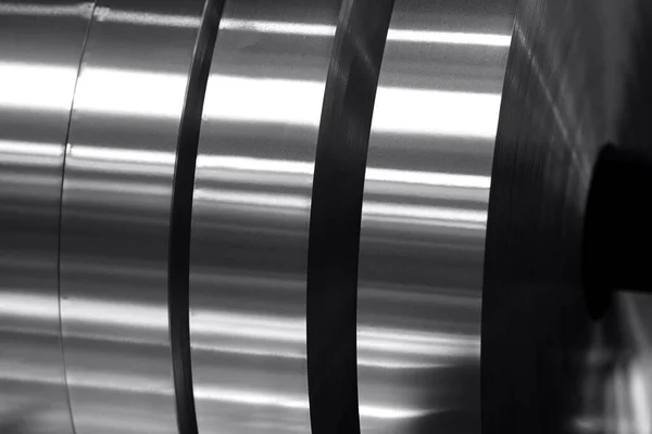 aluminum strips wound on coils, industrial background photo in black and white
