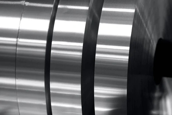 aluminum strips wound on coils, industrial background photo in black and white