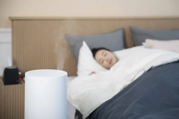 air purifier in bedroom, Asian woman sleeping
