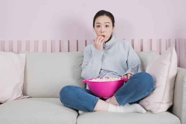 single solo woman living alone concept watching television, movie with popcorn