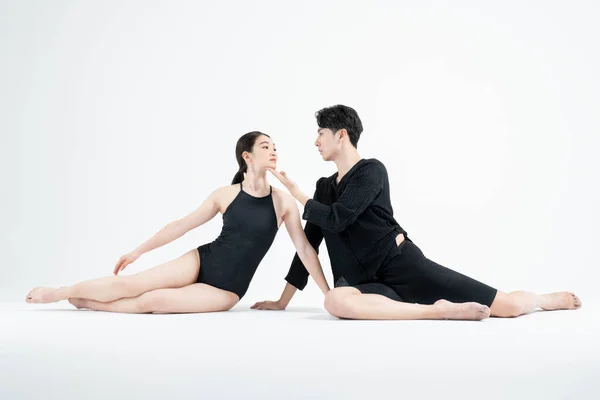 male and female couple modern contemporary dancers making moves in white background setting