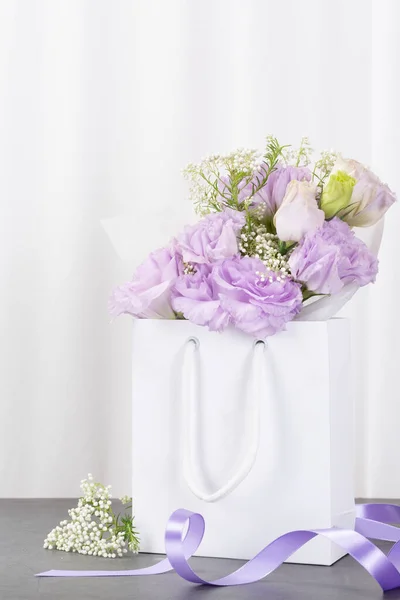 purple flower in paper bag