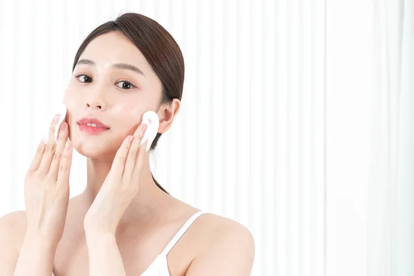 Beautiful Asian model face and peeling pad, skin beauty concept