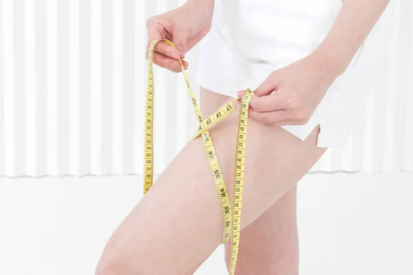leg and tape measure, body size and diet concept