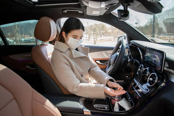 Asian woman wearing mask in car, covid virus