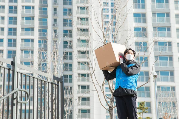 Asian delivery man working with mask