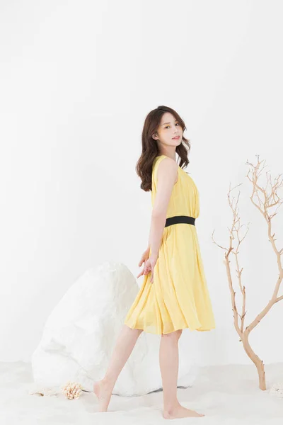 beautiful Asian model in yellow dress, spring beauty concept