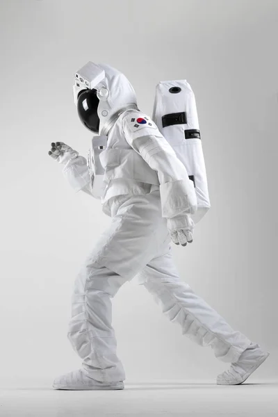 Vigorous walking astronaut, white background