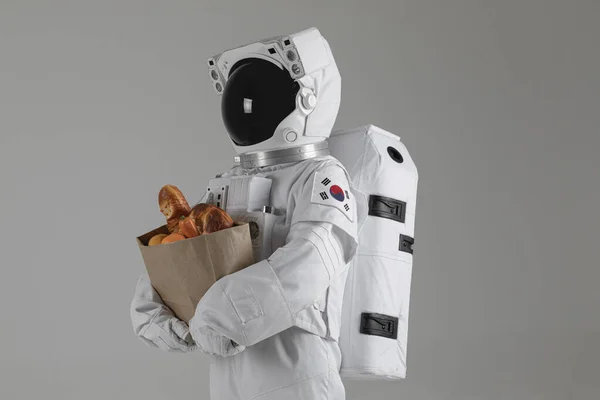 Astronauta Gospodarstwa Torba Papierowa Żywnością Białe Tło — Zdjęcie stockowe