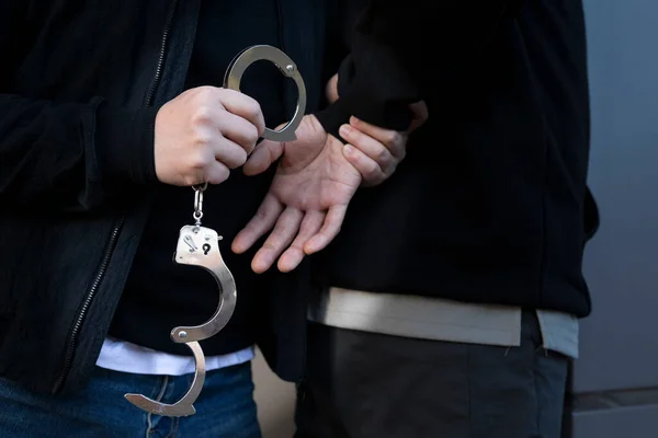 criminal handcuffed by police detective